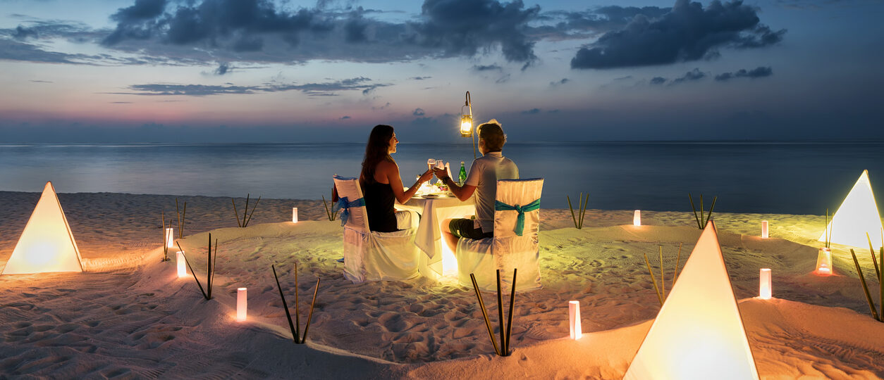 Honeymoon couple is having a private, romantic dinner