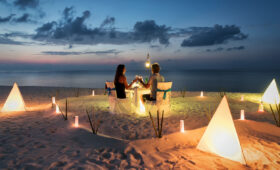 Honeymoon couple is having a private, romantic dinner